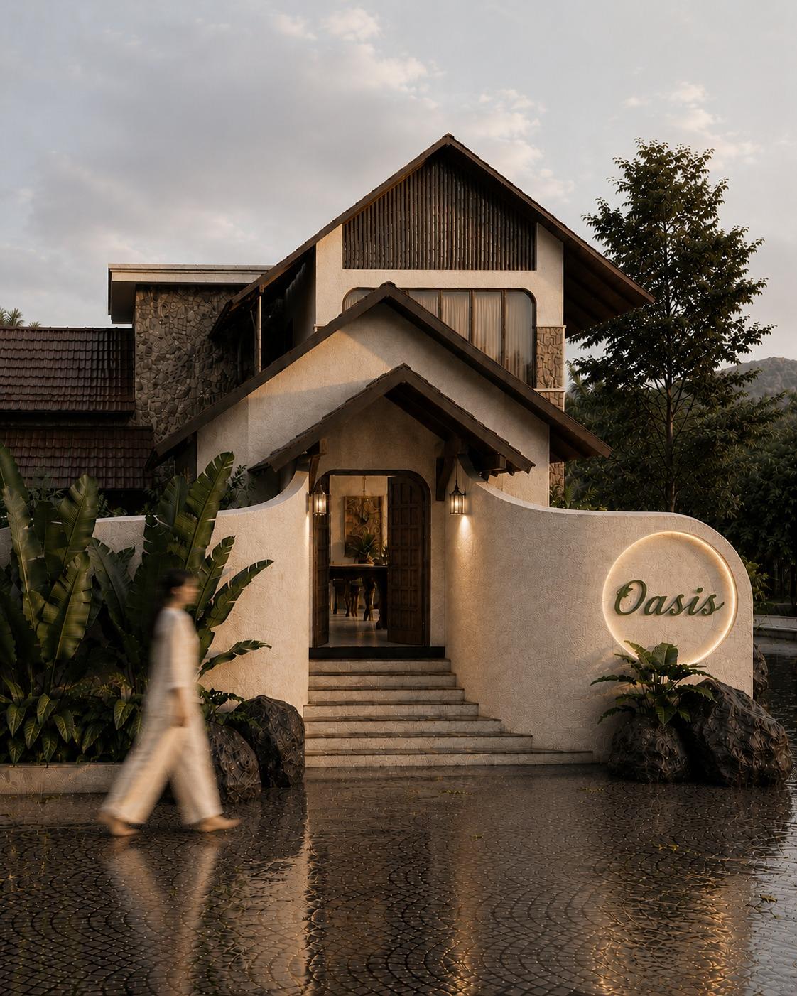 The entrance pavilion: a slatted timber gable above an arched teak door, lantern sconces, a sweeping curved wall and wet cobbled forecourt at dusk